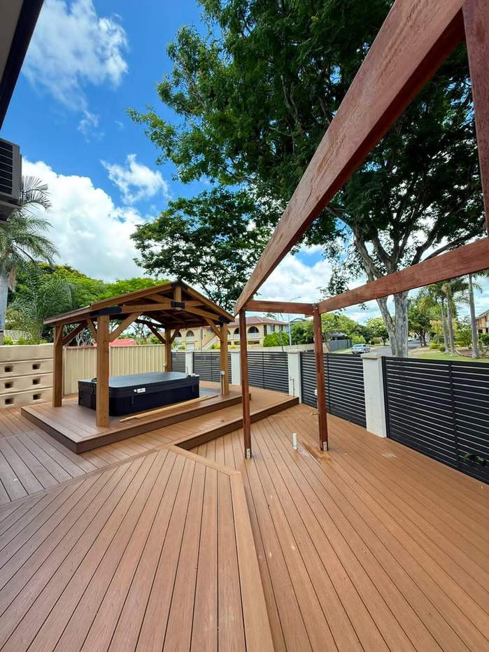 New timber decking with a pergola frame, a raised spa platform and a gazebo