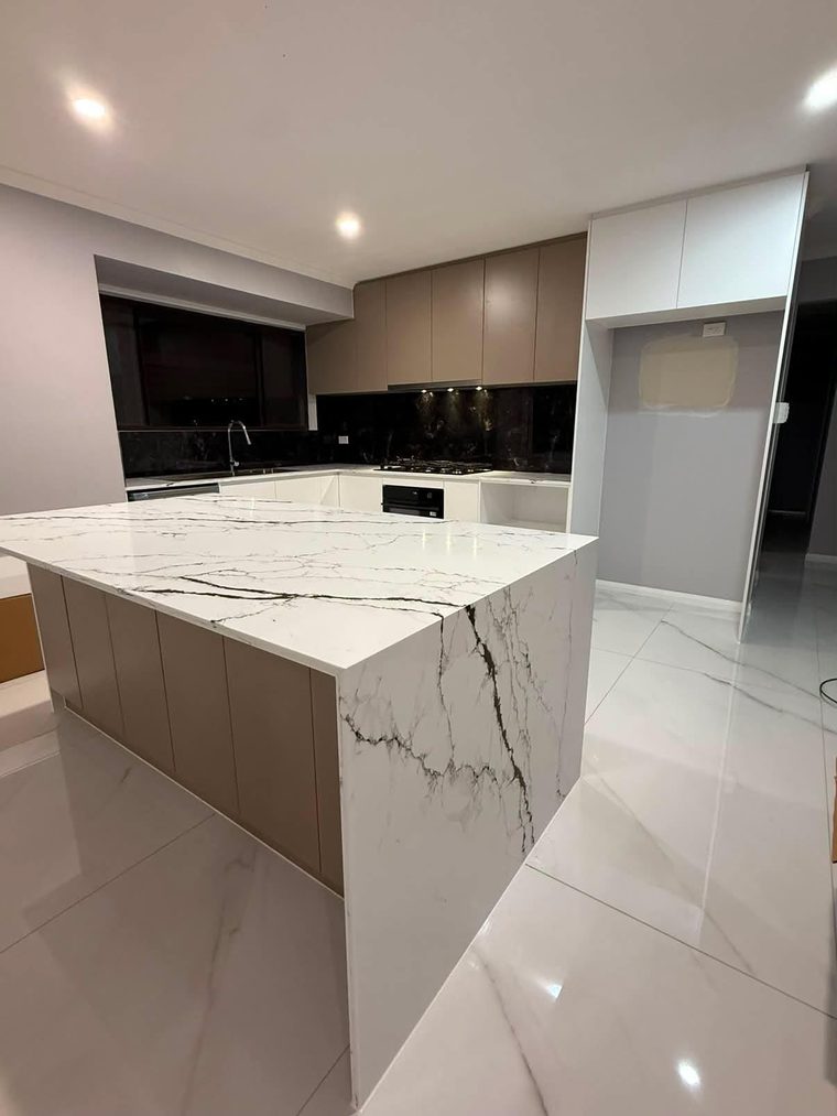 Kitchen renovation with a marble-look waterfall island and full-height joinery